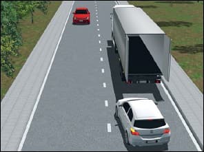 Vue 3D d'une route à deux sens : un camion aux portes arrière ouvertes occupe le côté droit de la chaussée ; une voiture blanche, derrière lui, clignote à gauche pour le contourner ; une voiture rouge arrive en face.